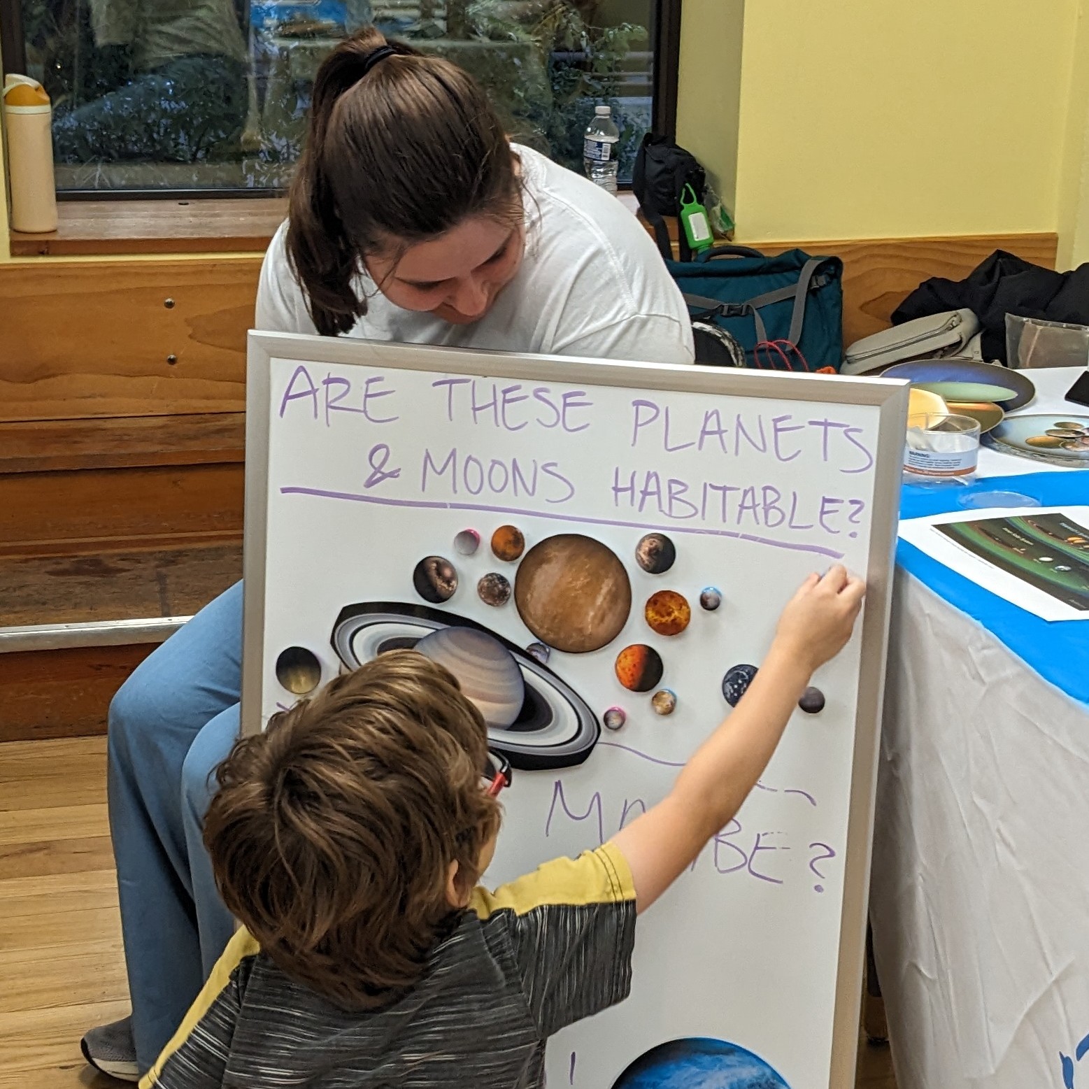 Child Attendee and WiCOR Grad Student interact with the Exoplanet activity at Science on the Square