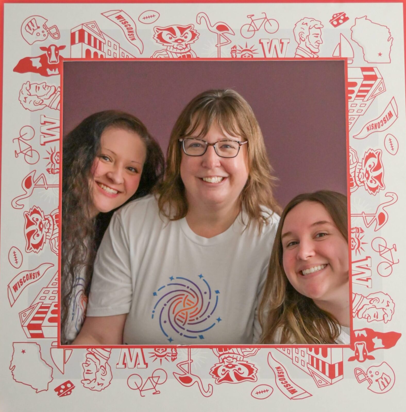 Susana Widicus Weaver with two graduate students in a  hand-held, UW-themed photo frame